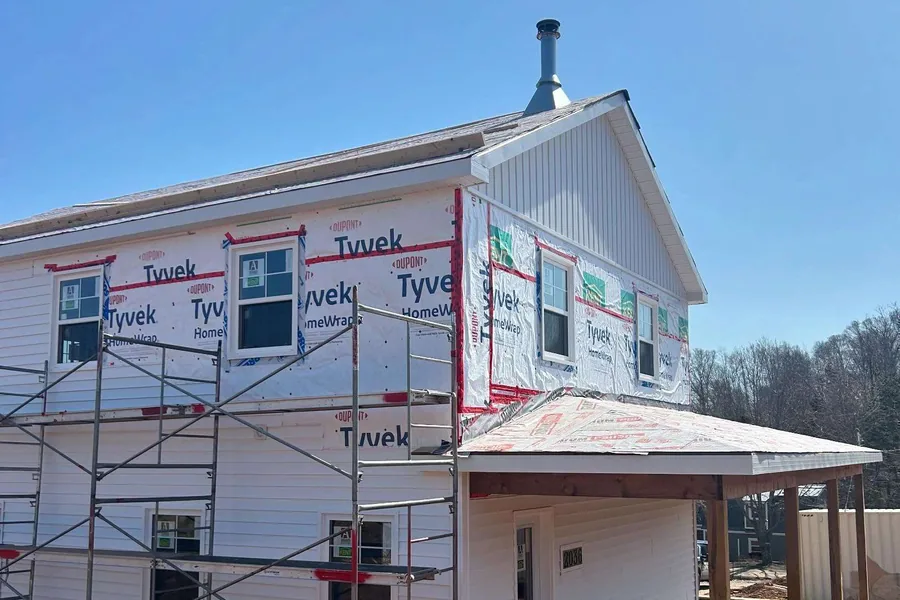 A two-storey Tipple build wrapped and scaffolded along the gable end.